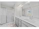 This modern bathroom has a double vanity, a large mirror and a glass enclosed shower at 220 Brisbane Dr, Zebulon, NC 27597