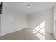 An empty room with a door, a window, neutral walls and carpeting at 220 Brisbane Dr, Zebulon, NC 27597