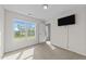 A bedroom has a window, a TV, neutral walls and carpeting at 220 Brisbane Dr, Zebulon, NC 27597