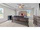 This spacious bedroom features a decorative ceiling fan, a bed with a tufted headboard and two windows at 220 Brisbane Dr, Zebulon, NC 27597