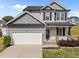 Charming two-story home with a two car garage, landscaped yard and a welcoming front porch at 220 Brisbane Dr, Zebulon, NC 27597