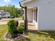 Inviting covered porch with brick detail, complemented by lush landscaping and a well-manicured lawn at 220 Brisbane Dr, Zebulon, NC 27597