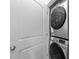 A laundry closet contains a stacked washer and dryer at 220 Brisbane Dr, Zebulon, NC 27597