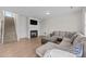 Cozy living room features a fireplace, built-in shelving, and a comfortable sectional sofa on wood floors at 220 Brisbane Dr, Zebulon, NC 27597