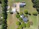 Aerial view of the property showing the house, outbuildings, and surrounding greenery at 220 Jordan Narron Rd, Selma, NC 27576