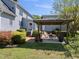 Backyard view featuring a covered outdoor kitchen, patio, and plenty of greenery for privacy at 220 Jordan Narron Rd, Selma, NC 27576