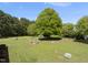 Expansive backyard with mature trees and planting beds, creating a peaceful outdoor retreat at 220 Jordan Narron Rd, Selma, NC 27576