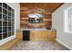 Indoor bar area featuring wood walls, granite counter tops, sink, a mini fridge, and a tv at 220 Jordan Narron Rd, Selma, NC 27576