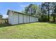 Exterior view of the well-maintained, bright white barn on a lush green lawn at 220 Jordan Narron Rd, Selma, NC 27576