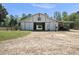 Exterior view of the horse barn featuring an open doorway and visible horse stalls at 220 Jordan Narron Rd, Selma, NC 27576