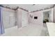 Full bathroom featuring tiled floors, a tub and shower combination, and vertical striped wallpaper at 220 Jordan Narron Rd, Selma, NC 27576