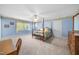 Spacious bedroom with a four-poster bed, large window, and blue walls, creating a serene atmosphere at 220 Jordan Narron Rd, Selma, NC 27576
