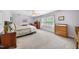 This bedroom is decorated with neutral walls, carpet floors, a ceiling fan, and lots of natural light at 220 Jordan Narron Rd, Selma, NC 27576