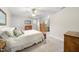 Cozy bedroom featuring soft carpeting, a comfortable bed, and natural light, perfect for relaxation at 220 Jordan Narron Rd, Selma, NC 27576