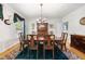 Traditional dining room features a chandelier, green accents, and a large wooden table for Gathering gatherings at 220 Jordan Narron Rd, Selma, NC 27576