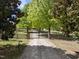 View of the property's gated entrance, driveway, and manicured surroundings at 220 Jordan Narron Rd, Selma, NC 27576