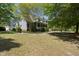 A view of the home's exterior showcasing its siding, covered porch, and surrounding greenery at 220 Jordan Narron Rd, Selma, NC 27576
