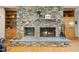 Stone fireplace with built-in shelving creates a cozy focal point in the living space at 220 Jordan Narron Rd, Selma, NC 27576