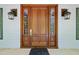 Elegant front door framed by sidelights and decorative sconces creates an inviting entryway at 220 Jordan Narron Rd, Selma, NC 27576