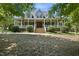 Charming home exterior featuring a welcoming front porch with ample seating and beautiful landscaping at 220 Jordan Narron Rd, Selma, NC 27576