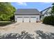 Spacious three-car garage exterior, adjacent to the home with a large concrete driveway at 220 Jordan Narron Rd, Selma, NC 27576