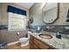 Charming half bath with a granite countertop, decorative mirror, and textured wallpaper for added character at 220 Jordan Narron Rd, Selma, NC 27576