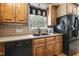 Kitchen boasts wood cabinets, modern appliances, a double sink, and a window for natural light while you cook at 220 Jordan Narron Rd, Selma, NC 27576