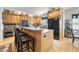 Open kitchen features wood cabinets, a breakfast bar, and modern appliances, ideal for cooking and casual dining at 220 Jordan Narron Rd, Selma, NC 27576