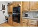 Close up view of a kitchen featuring stainless steel appliances, custom cabinets, and granite countertops at 220 Jordan Narron Rd, Selma, NC 27576