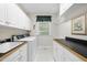 Functional laundry room features ample cabinet space, a sink, and a washer/dryer for added convenience at 220 Jordan Narron Rd, Selma, NC 27576