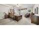 This main bedroom offers a four-poster bed, ceiling fan, and an abundance of natural light at 220 Jordan Narron Rd, Selma, NC 27576