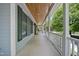 Spacious covered porch offers ample space for outdoor seating with scenic views of the property at 220 Jordan Narron Rd, Selma, NC 27576