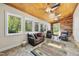Relax in this sunroom featuring wood walls, a ceiling with fans, windows, and comfortable seating at 220 Jordan Narron Rd, Selma, NC 27576