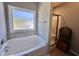 Bright bathroom featuring a soaking tub, and glass enclosed shower at 226 Kandypoo Dr, Four Oaks, NC 27524
