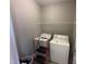 Functional laundry room with washer, dryer, and convenient overhead shelving unit at 226 Kandypoo Dr, Four Oaks, NC 27524
