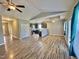 Open-concept living space with modern wood-look floors, vaulted ceilings, and seamless flow to the kitchen at 226 Kandypoo Dr, Four Oaks, NC 27524