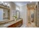 This bathroom offers dual sinks, granite countertop, and tile flooring at 2307 Carriage Oaks Dr, Raleigh, NC 27614