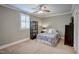 Cozy bedroom with a ceiling fan, window with shutters, and neutral paint at 2307 Carriage Oaks Dr, Raleigh, NC 27614