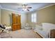 Bright bedroom featuring a ceiling fan, a wooden armoire, and a white crib at 2307 Carriage Oaks Dr, Raleigh, NC 27614