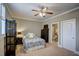 Cozy bedroom with a ceiling fan, a window with shutters, and an ensuite bathroom at 2307 Carriage Oaks Dr, Raleigh, NC 27614