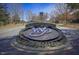 Community entrance with manicured landscaping and clear signage at 2307 Carriage Oaks Dr, Raleigh, NC 27614