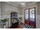 Welcoming foyer with hardwood floors, elegant lighting, and a stylish secretary desk at 2307 Carriage Oaks Dr, Raleigh, NC 27614
