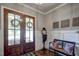 Bright foyer with hardwood floors, decorative bench, and a view of the front door with wreaths at 2307 Carriage Oaks Dr, Raleigh, NC 27614
