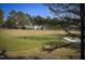 Scenic golf course view with lush green fairways and surrounding mature trees at 2307 Carriage Oaks Dr, Raleigh, NC 27614