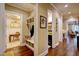 Hallway featuring a built-in bench with storage and access to various rooms, including an office and powder room at 2307 Carriage Oaks Dr, Raleigh, NC 27614