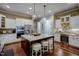 Open concept kitchen with a large island, wine fridge, stainless steel appliances and a breakfast bar at 2307 Carriage Oaks Dr, Raleigh, NC 27614