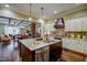 Spacious kitchen with granite counters, stainless steel appliances, and a view into the dining room at 2307 Carriage Oaks Dr, Raleigh, NC 27614