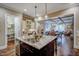 Gourmet kitchen features an island with stainless steel appliances, granite countertops, and hardwood floors at 2307 Carriage Oaks Dr, Raleigh, NC 27614