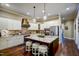 Charming kitchen features an island with breakfast bar, custom cabinetry and stainless steel appliances at 2307 Carriage Oaks Dr, Raleigh, NC 27614
