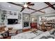 Inviting living room with fireplace and ceiling beams open to dining area and kitchen at 2307 Carriage Oaks Dr, Raleigh, NC 27614